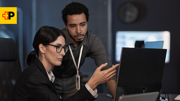 Woman an man before a screen